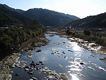 The Kumozu River cuts through a valley between mountains.