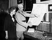 A woman and a man looking at a map