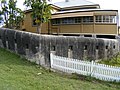 A side view of the officers quarters with fortified wall in view