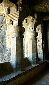 Cave No.3 pillars (back view). They have no base, and "stand on a bench in the veranda, and in front of them is a carved screen".[8]