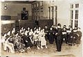 1939年，高雄首创高雄市混声合唱团，图为其表演前于高雄女中礼堂内练习的画面，中间指挥者为女中教师宫崎千藏。[46]
