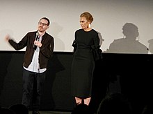 Aster and Collette standing onstage