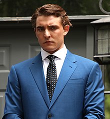 Jacob Wohl wearing a blue suit and black patterned tie