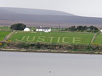 Aerial view of the word "Justice" mowed on a hayfield