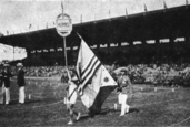 The Philippine delegate holding the two flags for the opening ceremony