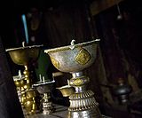 Butter lamps at the altar of the main temple