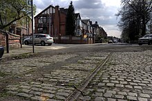 Tramlines running along a cobbled road in Broughton.