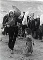 Palestinian woman, a child and a jug