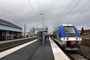 Blue-and-silver train at island platform