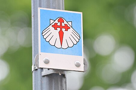 Waymark of the Way of St. James (white shell, red cross) in the city center of Zittau, Saxony, Germany.