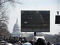 A Washington DC JumboTron screen showing the crowded National Mall during the 2009 United States Presidential Inaguration. The US Capitol can be seen in the background.