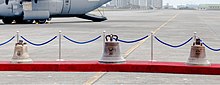 The Balangiga bells on display during a repatriation ceremony at Villamor Air Base. The left bell had been kept by the Army's 9th Infantry Regiment at Camp Red Cloud in South Korea; it is the smallest of the three. The bell in the center is the largest; it and the right bell had been displayed at the F.E Warren Air Force Base's Trophy Park in Cheyenne, Wyoming.