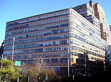 View of the Starrett-Lehigh Building as seen from Hudson River Park to the west. The building has a brick facade with large glass windows.