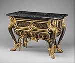 Commode; by André Charles Boulle; c. 1710–1732; walnut veneered with ebony and marquetry of engraved brass and tortoiseshell, gilt-bronze mounts, antique marble top; 87.6 x 128.3 x 62.9 cm; Metropolitan Museum of Art[164]