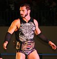 Austin Aries with the original design of the TNA World Tag Team Championship.