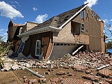 A severely-damaged brick house
