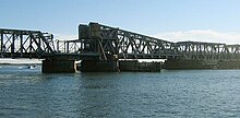 A large railway bridge over a wide river
