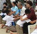 Image 51Display of respect of the younger towards the elder is a cornerstone value in Thailand. A family during the Buddhist ceremony for young men who are to be ordained as monks. (from Culture of Thailand)