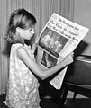 Image 30A girl reading a 21 July 1969 copy of The Washington Post reporting on the Apollo 11 Moon landing (from Newspaper)