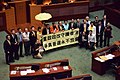 泛民主派议员在政改方案被否决后，到会议厅内主席台前展示标语