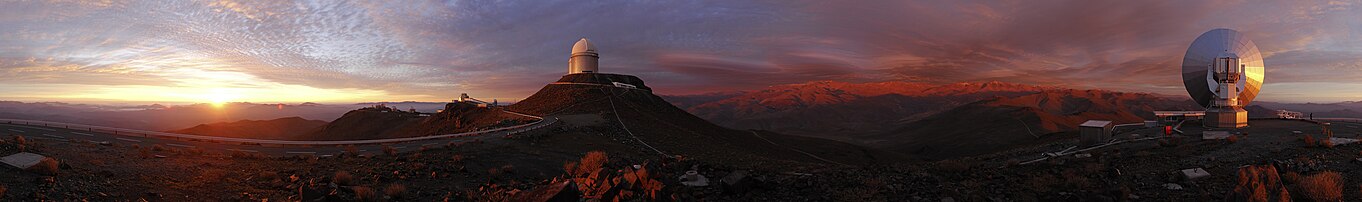 Panorama of La Silla at sunset with the ESO 3.6 m Telescope in the center and the decommissioned Swedish radio telescope in the foreground