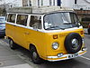 A yellow and white Volkswagen T2 campervan