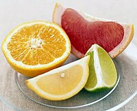 Wedges of pink grapefruit, lime, and lemon, and a half orange (clockwise from top)