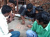 A-3. (Street game) Improvised with broken brick, a street board game in progress in Pondicherry, India.