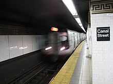 A "J" train entering the Nassau Street Line station at Canal Street