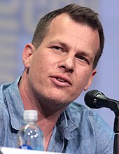 Jonathan Nolan is looking to his left