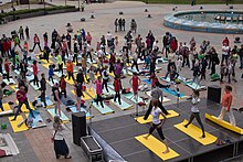 Photograph of people practising yoga in the street in Russia for the 2016 International Yoga Day