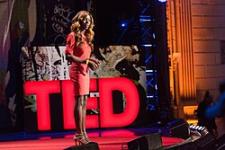 Daniella Carter on stage speaking to a crowd