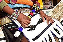 Brightly coloured and boldly patterned Ndebele beadwork and clothing