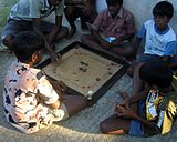B-4. (Carrom) A game of carrom in progress in Mamallapuram, Tamil Nadu.