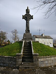 This is a photo of the memorial cross and the mound it sits upon with the limestone steps leading up to it