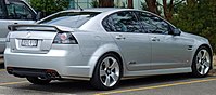 Rear-three-quarters view of a silver-coloured sedan