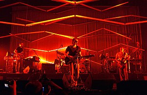 Atoms for Peace performing in 2010. From left to right: Nigel Godrich, Thom Yorke, Flea, and Mauro Refosco (obscured behind Flea, Joey Waronker behind the drums)