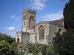 Stone building with square tower.