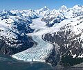 Aerial view of Marjorie Glacier with Mt. Salisbury, Mt. Tlingit, and Mt. Quincy Adams across the top of frame.