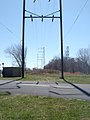 Abandoned K&T Branch, Behind Frankford Arsenal, 2006. Note rails disappearing into roadway for river access point