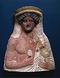 Dionysus holding an egg and a cock, terracotta from Tanagra, Greece, c. 350 BC