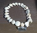 Image 16A necklace reconstructed from perforated sea snail shells from Upper Palaeolithic Europe, dated between 39,000 and 25,000 BCE. The practice of body adornment is associated with the emergence of behavioral modernity. (from Nudity)