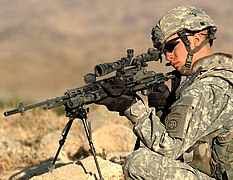 A soldier with an M14 equipped with a Sage M14ALCS chassis stock.