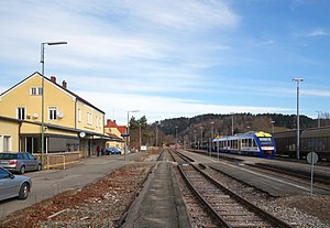 Two-story building in front of yard tracks