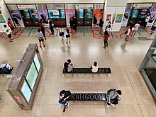 Two rectangular benches with the word "Serangoon" engraved on a black background.