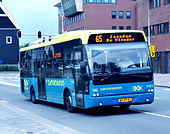 Blue-and-white bus, photographed at an angle