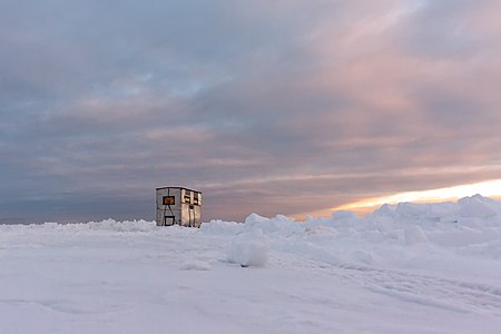 Ice fishing house at sunrise on Fishhook Lake in Park Rapids
