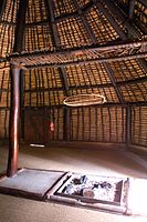 Interior view of hut with a hearth