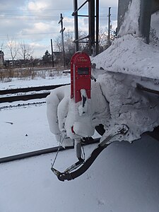 End-of-train devices must be made to withstand all kinds of weather. This one, attached to a covered hopper at the end of a long Canadian Pacific train, is still working even in the freezing winter cold.