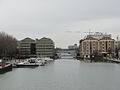 Bassin de la Villette in winter from the central footbridge towards the old warehouses with the old Grands Moulins de Pantin (Great Mills of Pantin) on the right